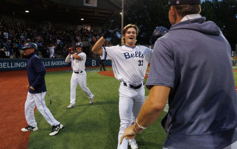 Bellingham's Coleman Schmidt (33) celebrates after his solo home run Aug. 9 that helped the Bells defeat Kelowna 5-3 in the first round of the West Coast League playoffs at home.