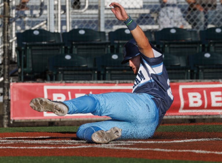 The Bellingham Bells' Brady Reynolds slides into home plate for the run Friday
