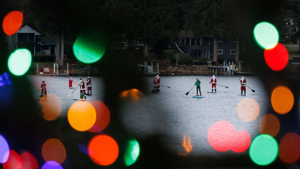 Through christmas lights, sixteen standup paddleboarders donned Christmas outfits and paddled on Lake Samish.