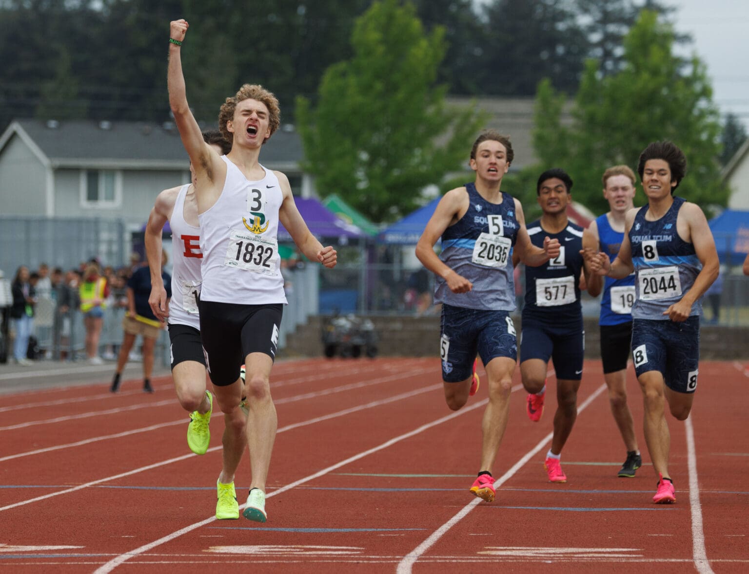 Sehome's Zack Munson raises a fist in the air as he crosses the finish line May 27 to win the 2A boys 800-meter run