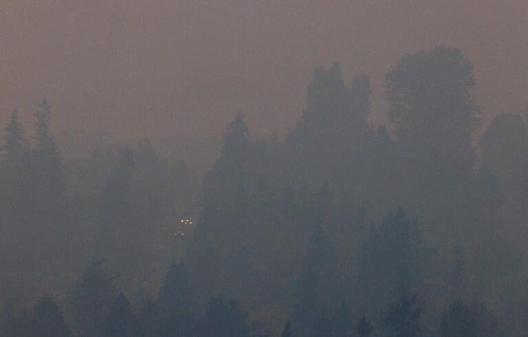 Car headlights shine through wildfire smoke in Bellingham's Happy Valley neighborhood in October 2022. The worst wildfire smoke of the 2023 season is expected this weekend.