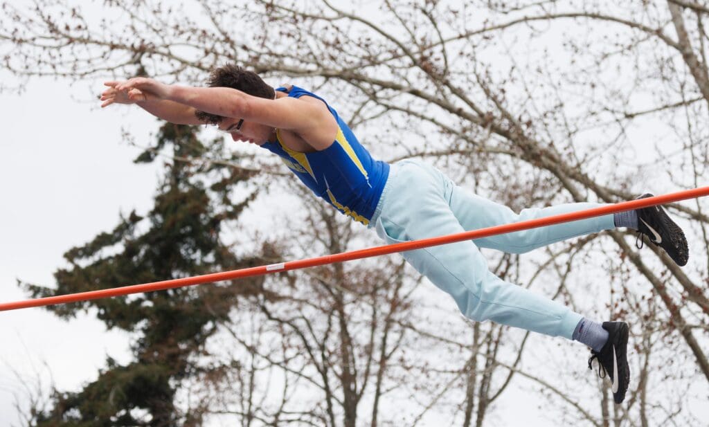 Ferndale's Andrew Finsrud clears the bar as his hands are outreached in a diving-like position.