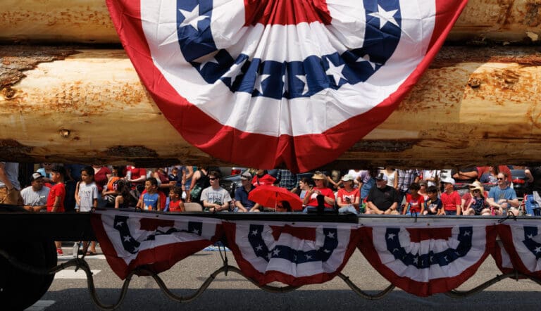 Crowds watch logging trucks go by at the Sedro-Woolley Fourth of July parade Tuesday