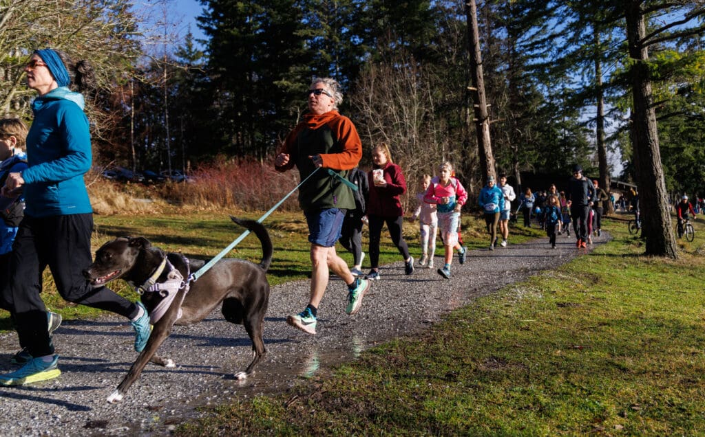 Participants start off the new year with a loop around the lake as runners jog along the path, some with their dogs.
