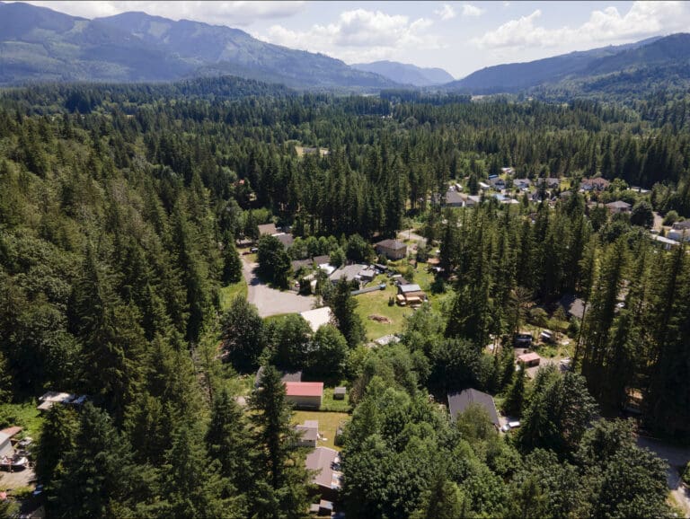 Aerial view of Peaceful Valley surrounded by dense forests.