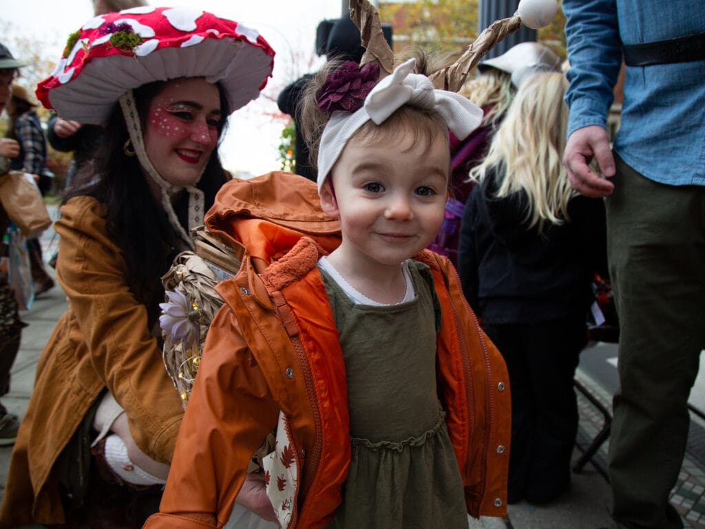 Saorise Hindman, 2, dons a snail costume, in tandem with her mom Katja dressed as a mushroom amongst the crowd of other Halloween participants.