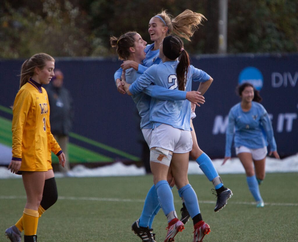 Western players hug Tera Zierner and lift her off the ground in celebration.