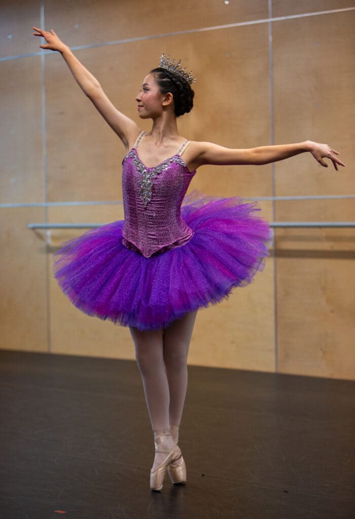 Jina Thompson is the Sugar Plum Fairy practices in a purple tutu.