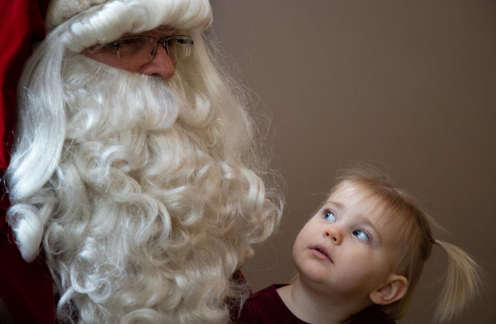 Ellie Brownell looks up at Santa Claus.