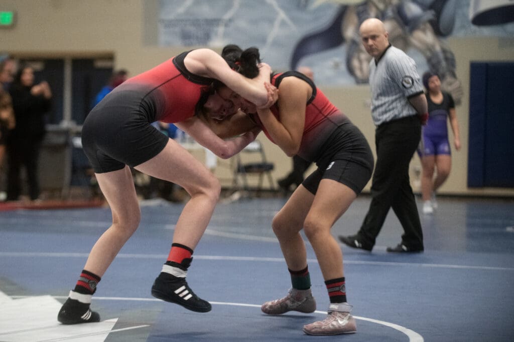 Mount Baker's Karalyn Cook and Ana Camacho wrestle as they hold onto each other's shoulders and neck to gain control of the match.