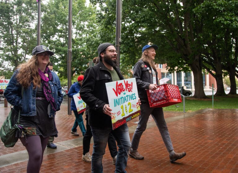 Members of Community First Whatcom bring petitions for tenant protections and a higher minimum wage June 20 to Bellingham City Hall. The initiatives will be up to voters on the ballot this November.