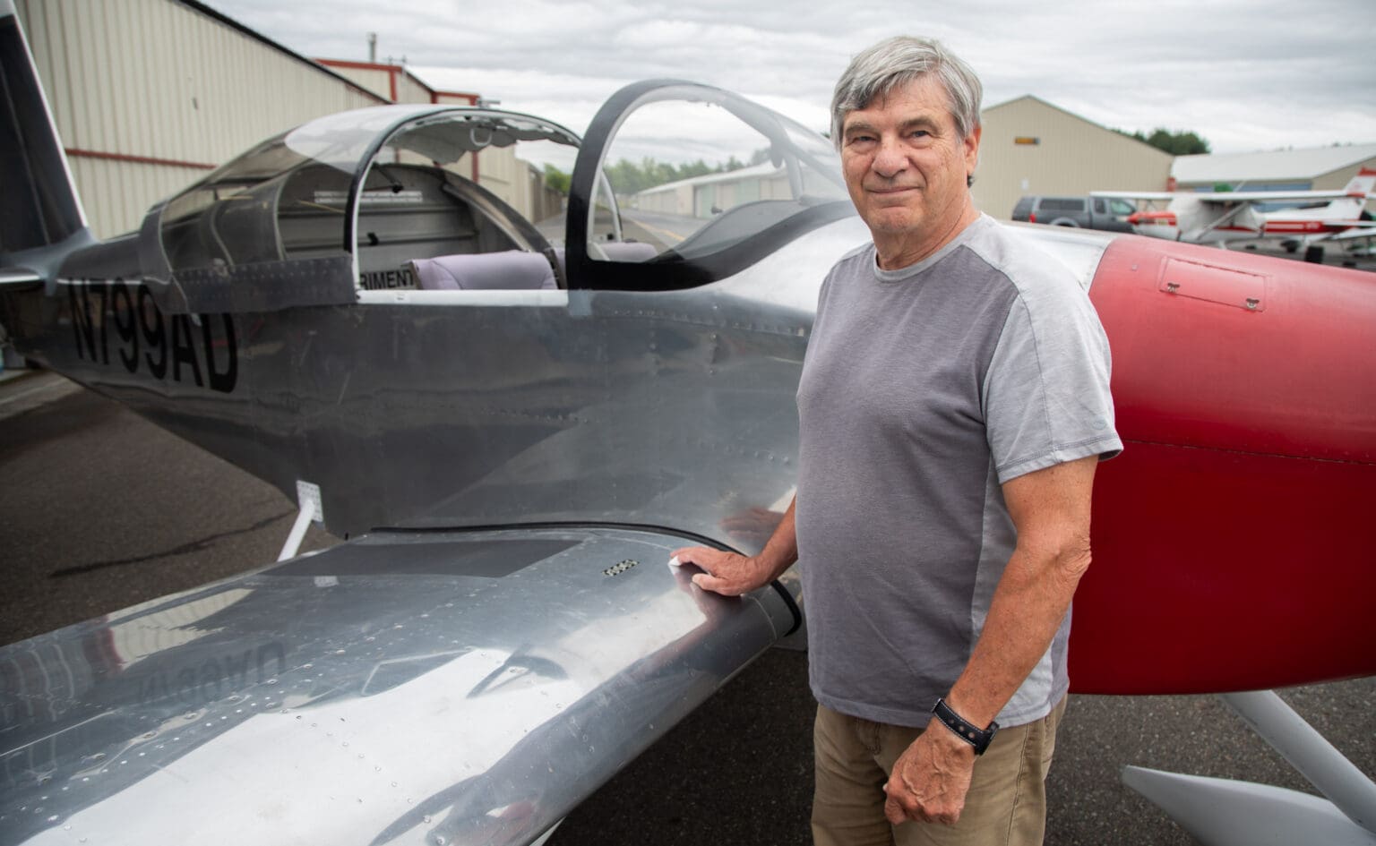 Mike MacKay stands with his plane