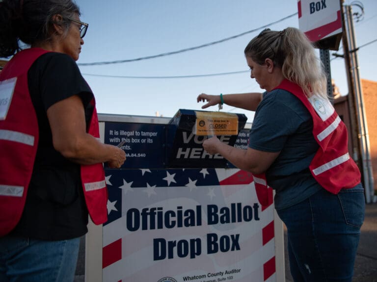 Election officials seal the ballot drop box at Grand Avenue at precisely 8 p.m. on primary Election Day.