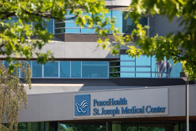 PeaceHealth's front entrance has its dove logo next to the name of the clinic.