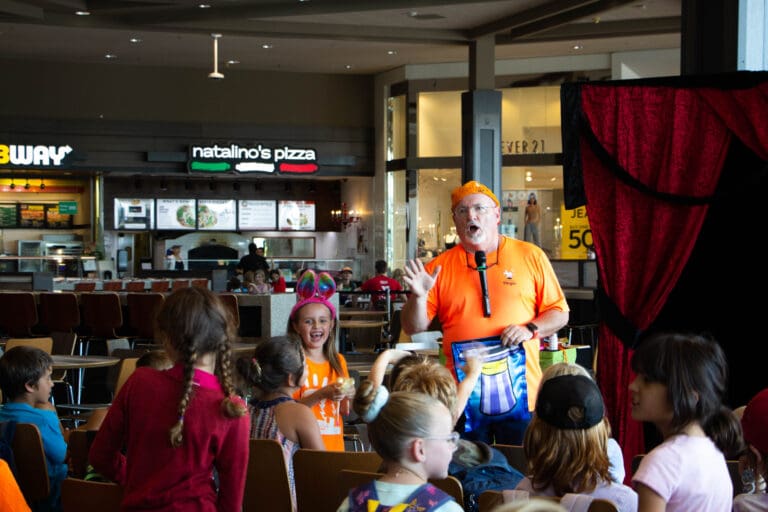 JR Russell Magic performs for a group of youth during a back-to-school event at Bellis Fair mall Tuesday