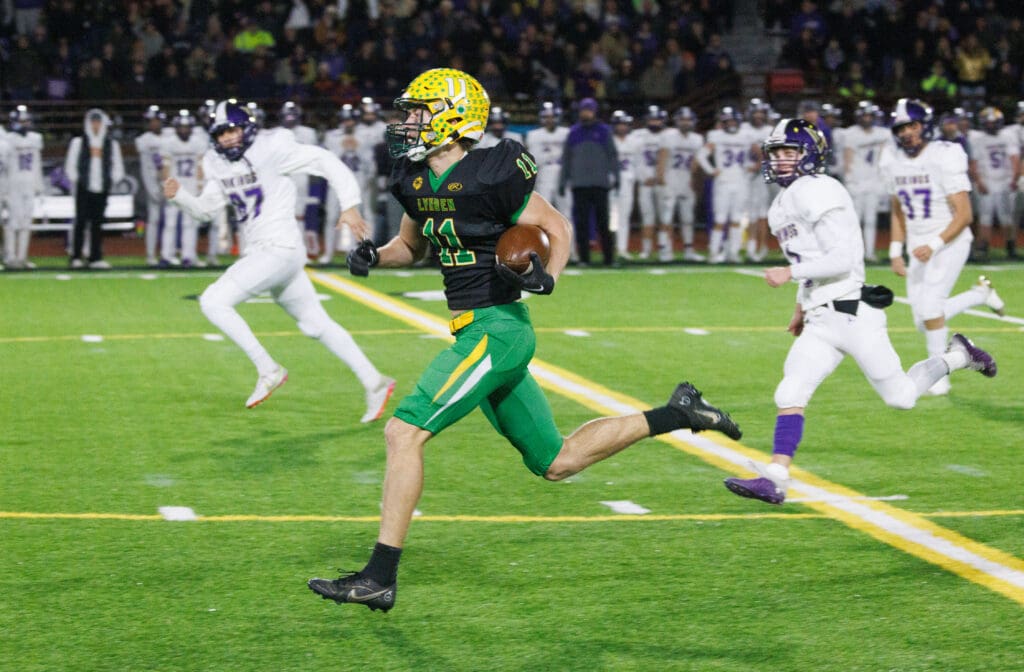 Lynden's Troy Petz running away from the opposing team with the football in hand.
