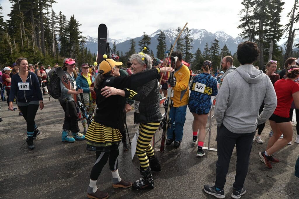Becky Brunk, right, hugs teammate Deb Gordon while wearing bee themed outfits.