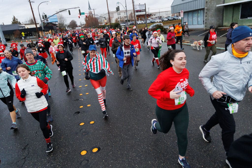 Runners head down Cornwall Avenue dressed in holiday colors.