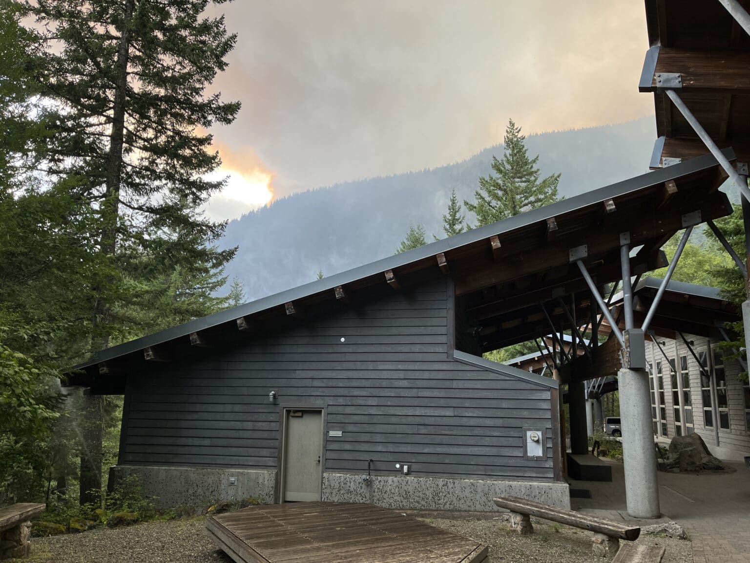 The North Cascades Institute's Environmental Learning Center campus pictured in August 2023 with the Sourdough Fire burning nearby. The center canceled all of its on-site programs for the rest of the year