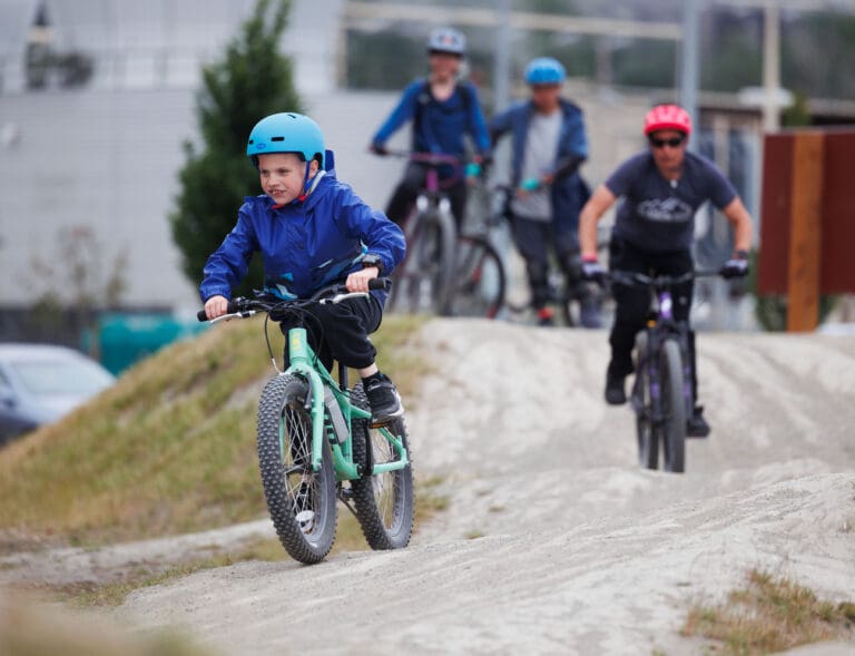 Cole Weathermon leads L.C. "Spike" Osadchuk around the pump track June 9 in Bellingham. The riders are part of The AIROW Project’s Riding For Focus group