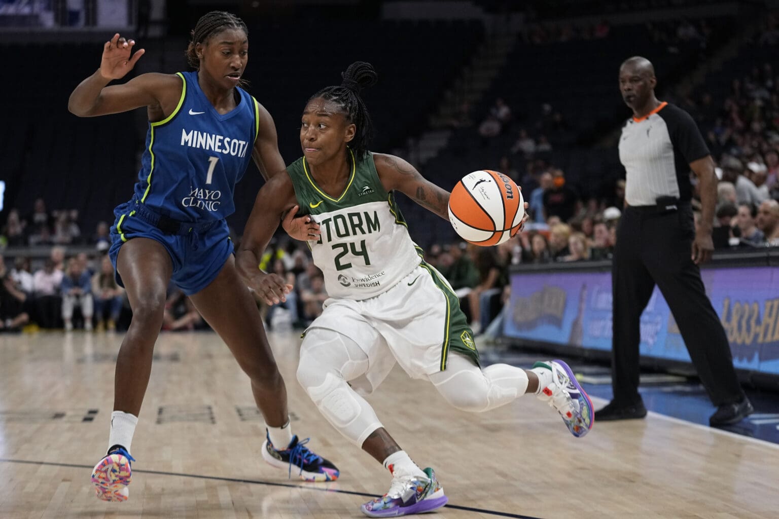 Seattle Storm guard Jewell Loyd (24) works toward the basket against Minnesota Lynx guard Diamond Miller (1) during the first half of a WNBA basketball game Tuesday
