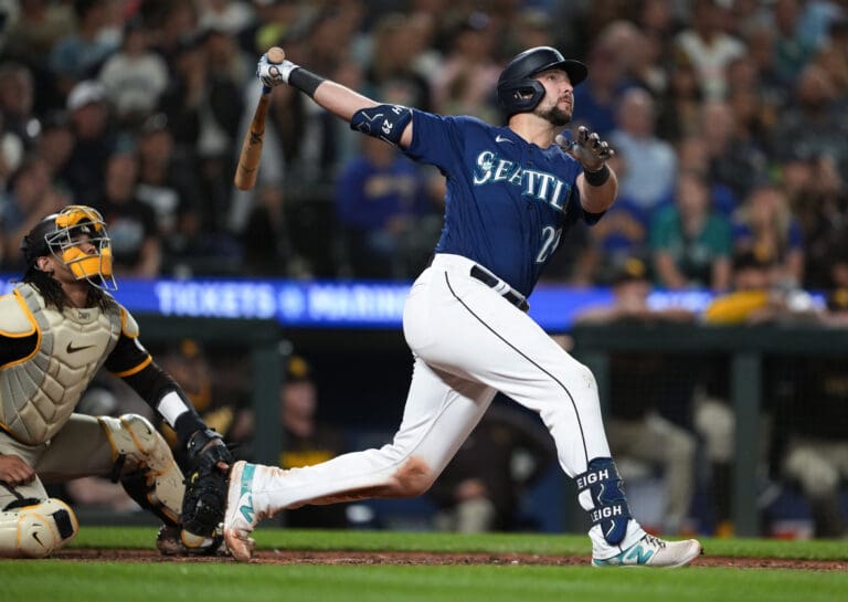Seattle Mariners' Cal Raleigh watches his two-run home run next to San Diego Padres catcher Luis Campusano during the eighth inning of a baseball game Wednesday