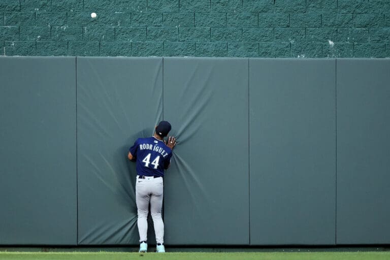 Seattle Mariners center fielder Julio Rodriguez chases after a three-run home run hit by Kansas City Royals' Salvador Perez during the first inning of a baseball game Monday