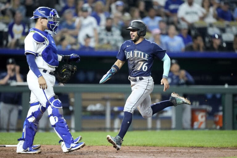 Seattle Mariners' Jose Caballero (76) runs home to score on a two-run single hit by Ty France during the 10th inning of a baseball game against the Kansas City Royals Tuesday