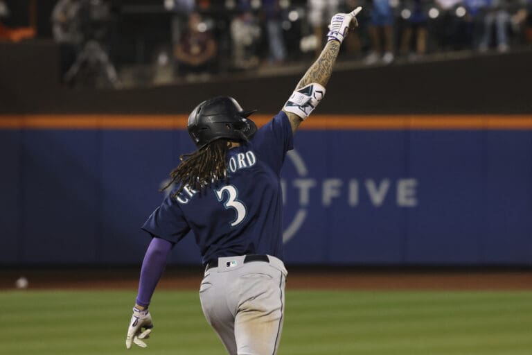 Seattle Mariners' JP Crawford celebrates as he rounds the bases after hitting a home run during the ninth inning of a baseball game against the New York Mets