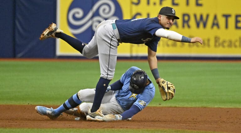 Seattle Mariners' Josh Rojas watches his throw to first base to complete a double play after forcing out Tampa Bay Rays' Josh Lowe at second base Sept. 10 in St. Petersburg