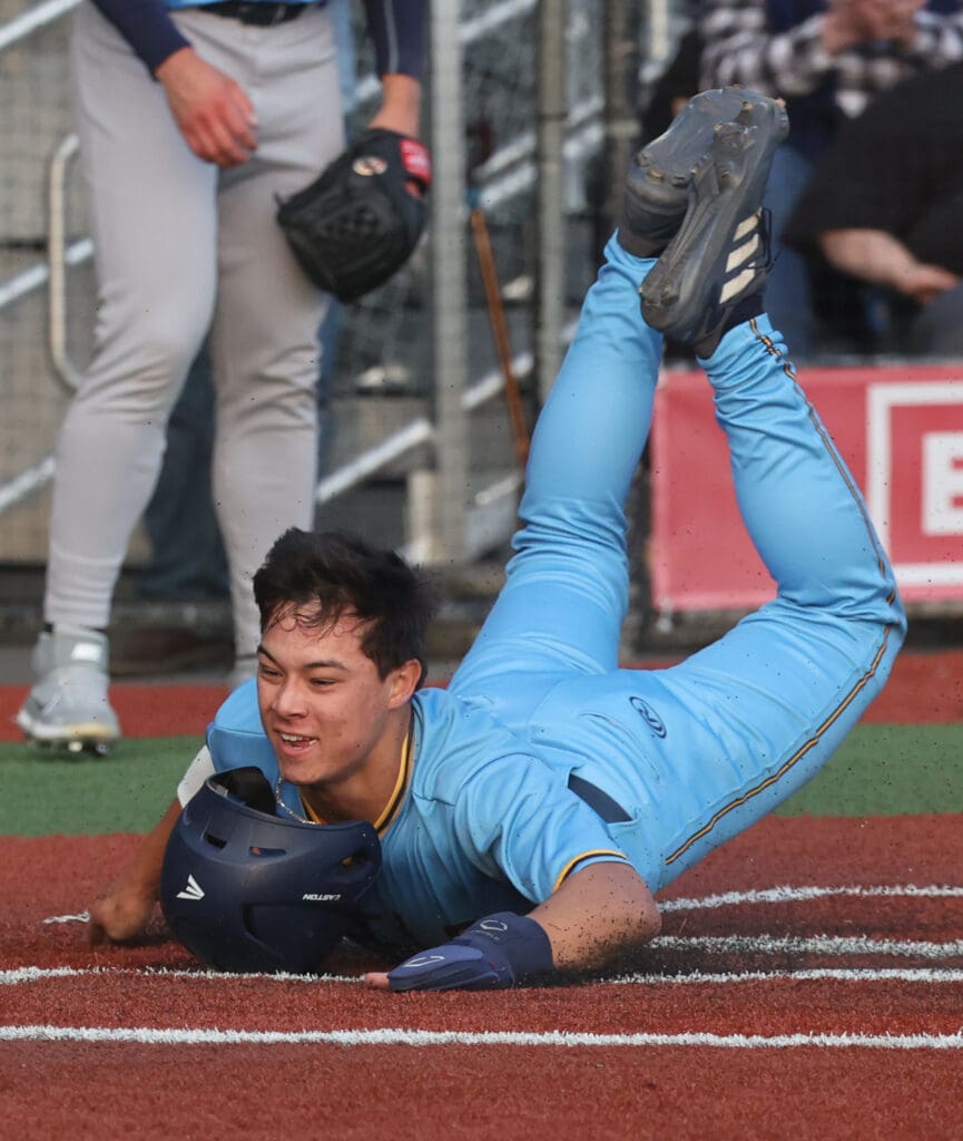 Bellingham Bells’ Cole Yoshida slides home for the first run of the game.