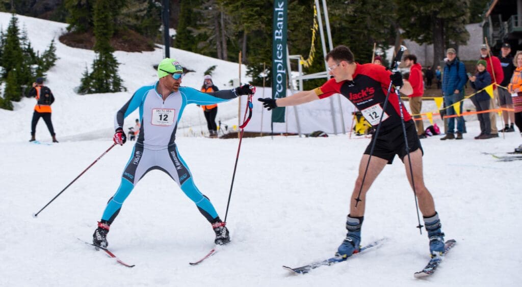 Brian Gregg hands off to Calvin Collander to begin the downhill ski leg.