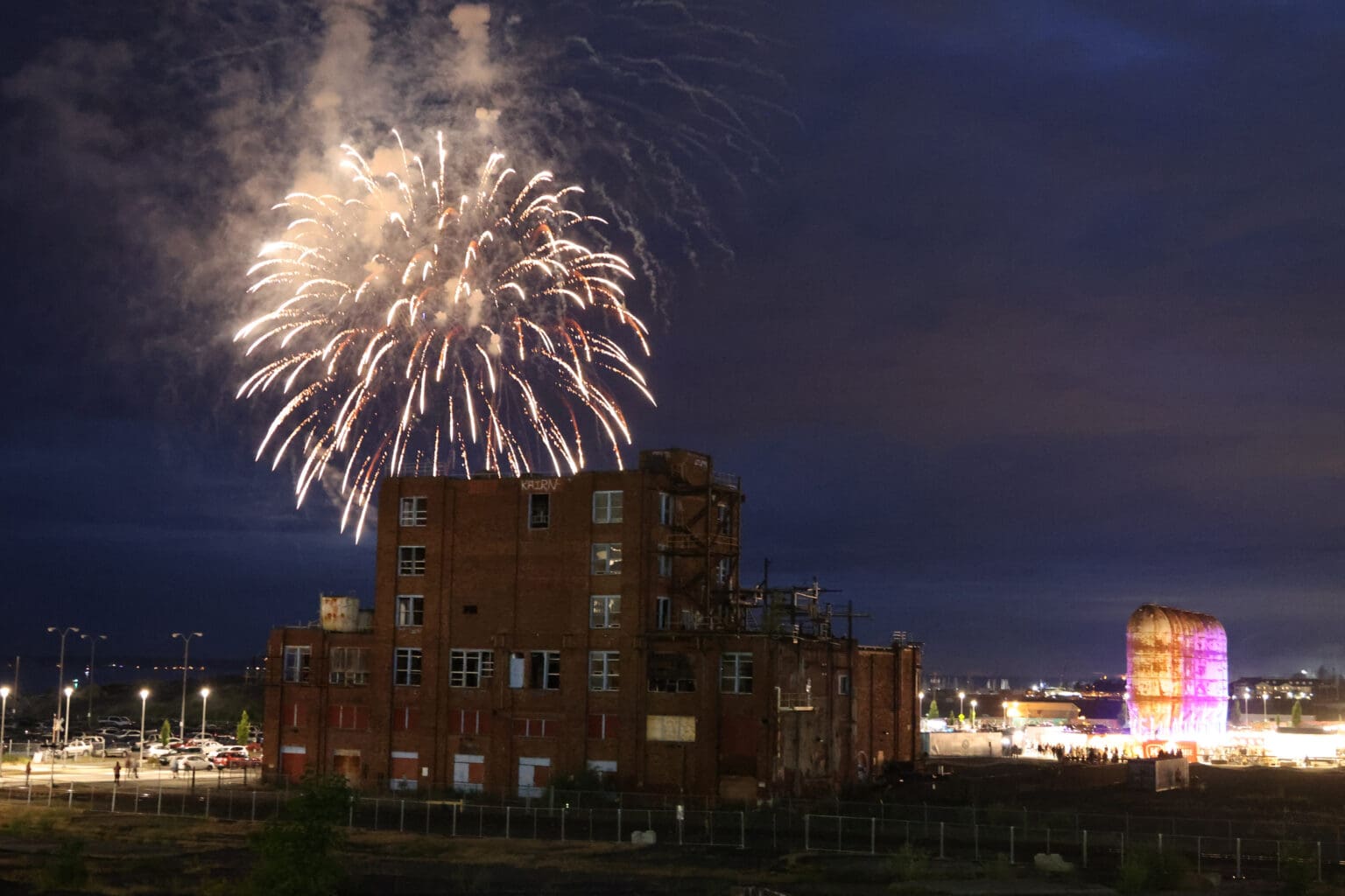 Fireworks explode behind the Georgia-Pacific Alcohol Plant building July 4