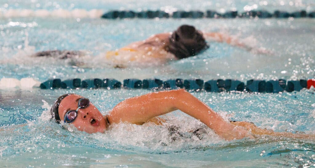 Annika Holland laps another swimmer as she passes by to win the 200-yard freestyle.