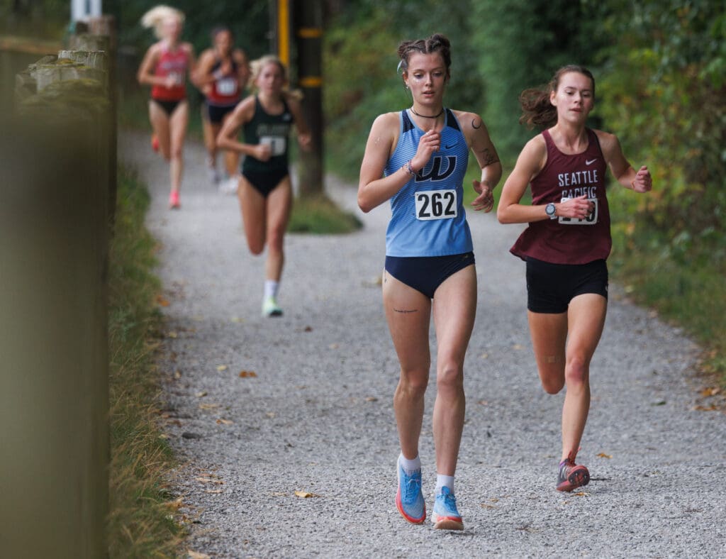 Western Washington University's Ashley Reeck heads to the finish line side by side with another runner as they both lead a trail of runners behind them.
