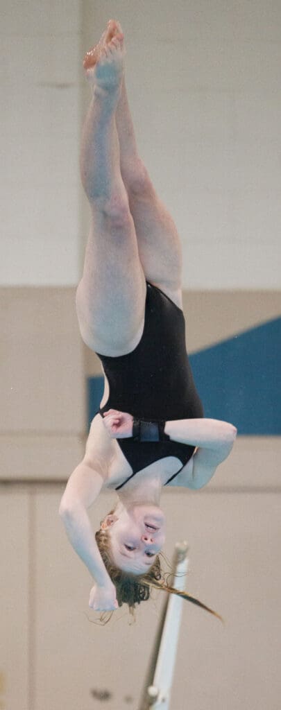 Sehome’s Madi Ferrari twists mid-dive as she adjusts her arms for the water.