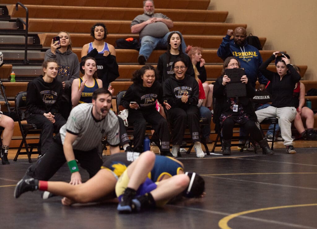 Ferndale's wrestling team cheers for Rockette Dishface Wednesday.
