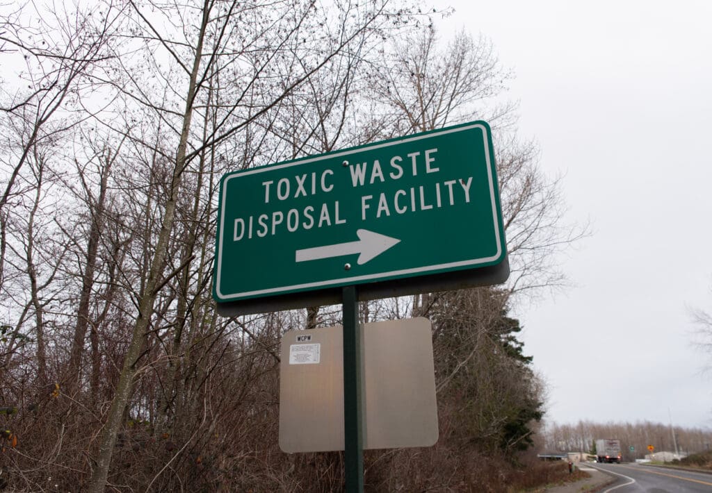 A road sign points toward the Whatcom County Disposal of Toxics Facility.