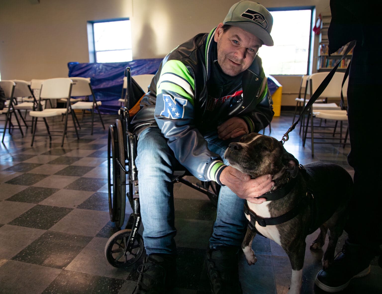 Martin pets Aja while at the warming shelter hosted by the City of Bellingham on Friday