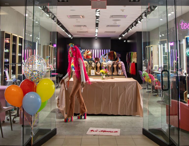 Miracle Jones organizes the inside of her shop while dressed in her signature multicolored style.