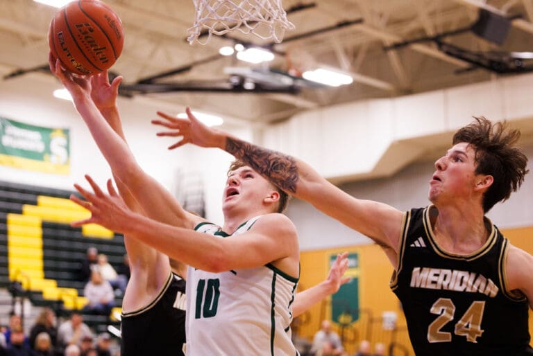 Sehome’s Austin McKay attempts a layup as defenders try to reach to block the shot.