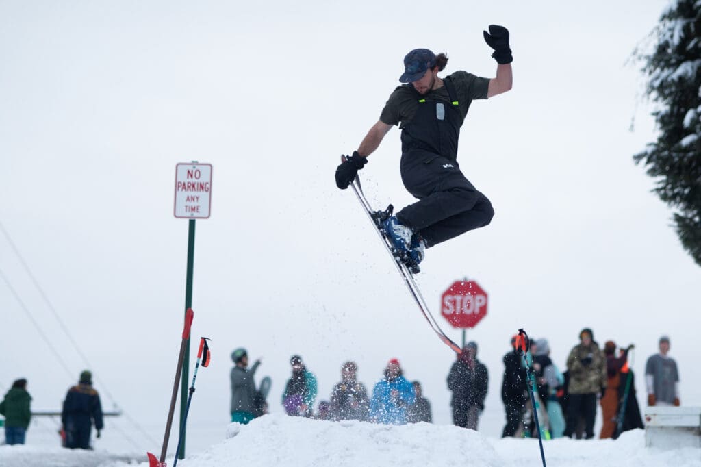 Kurtis Johnston sends a tail grab off a college-student-built snow jump on Maple Street in Bellingham.
