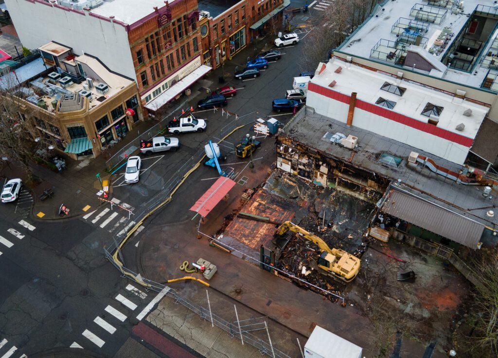 An aerial view of the streets blocked off as an excavator cleans up the remnants of the Terminal Building.