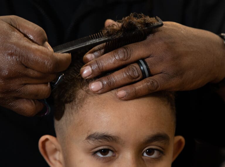 Bernard Franklin trims Quincy Dudley's hair on Jan. 17 at Busy B's Barber Shop & Salon. Dudley's mom Joy was excited to find a barbershop that could correctly cut and style Afro-textured hair.