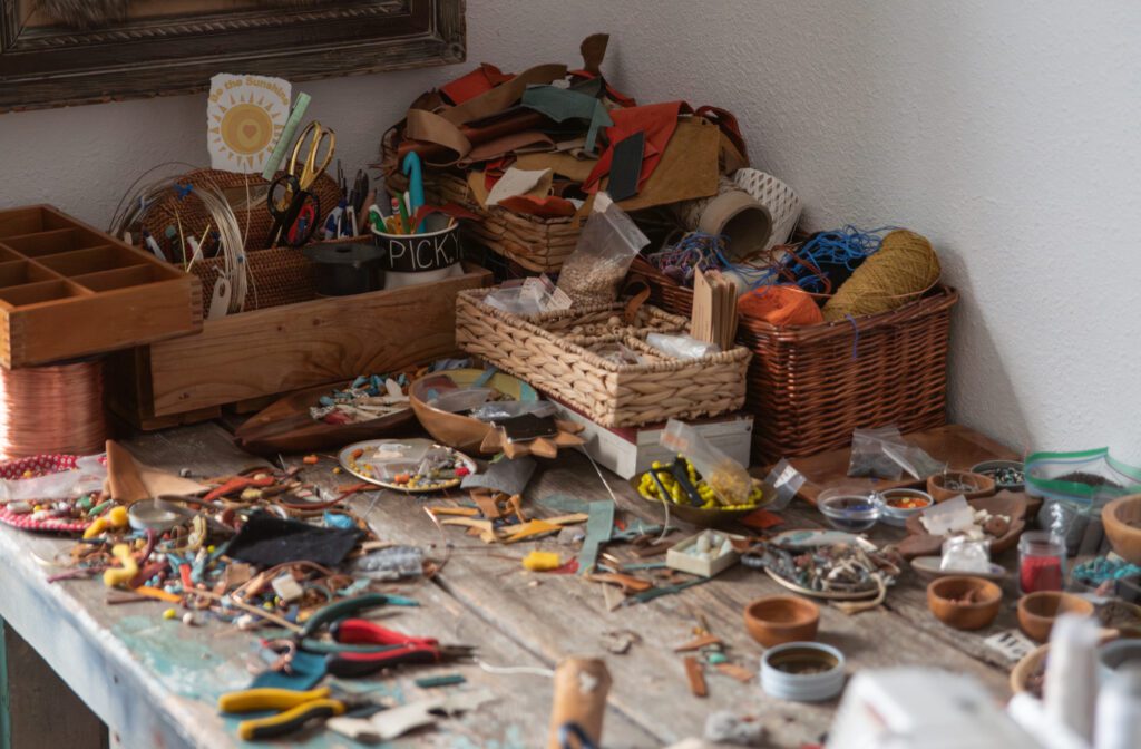 Materials lay scattered across Suzanne Lundberg's jewelry making table in her studio.