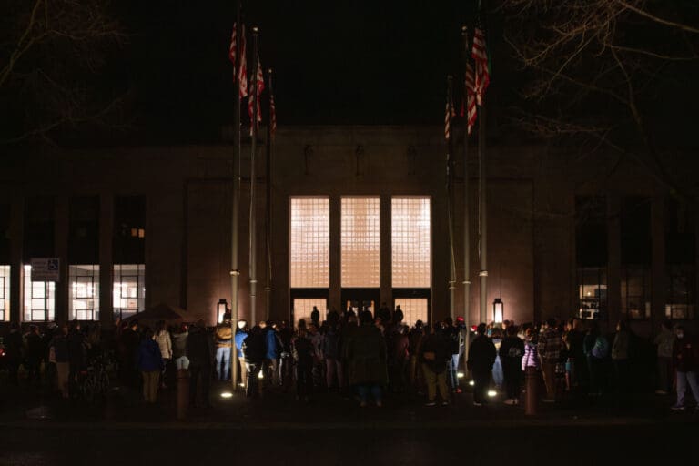A crowd observes the memorial in front of Bellingham City Hall Thursday