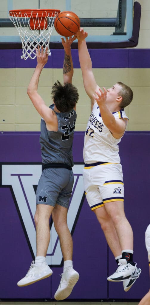 Nooksack Valley's Brady Ackerman blocks a shot by Meridian’s Christian Clawson as they both leap into the air for control of the ball.