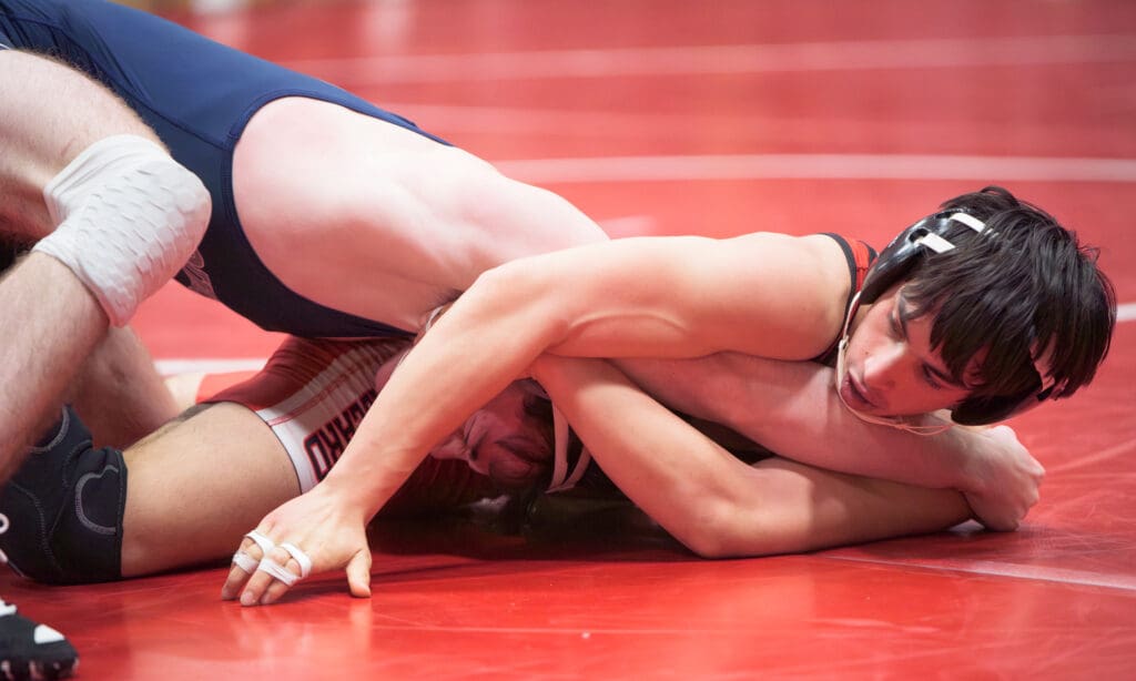 Squalicum's Griffin Smith tries to get out from under his Ballard opponent as his bottom half is in the air.