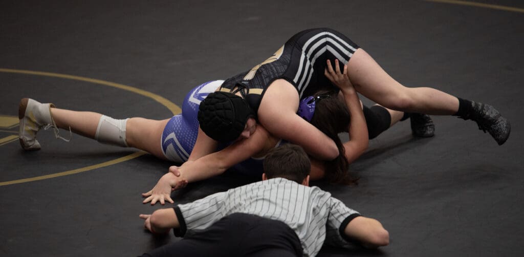 Meridian's Regan Swope rolls her opponent's shoulders toward the mat.