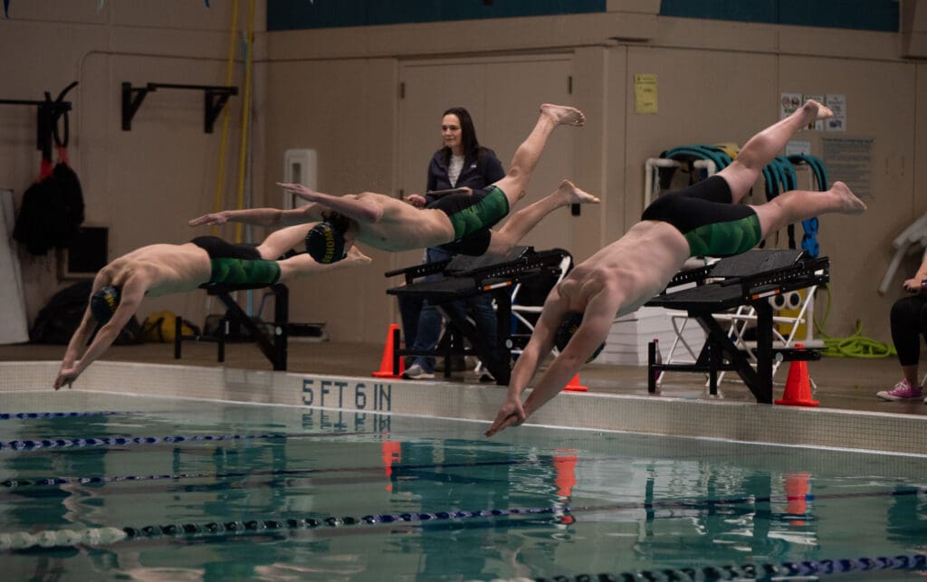 From left, Sehome's Sal Sanders, Koen Mathey and Jake Champagne begin the 200 freestyle as all three of them dive into the water.